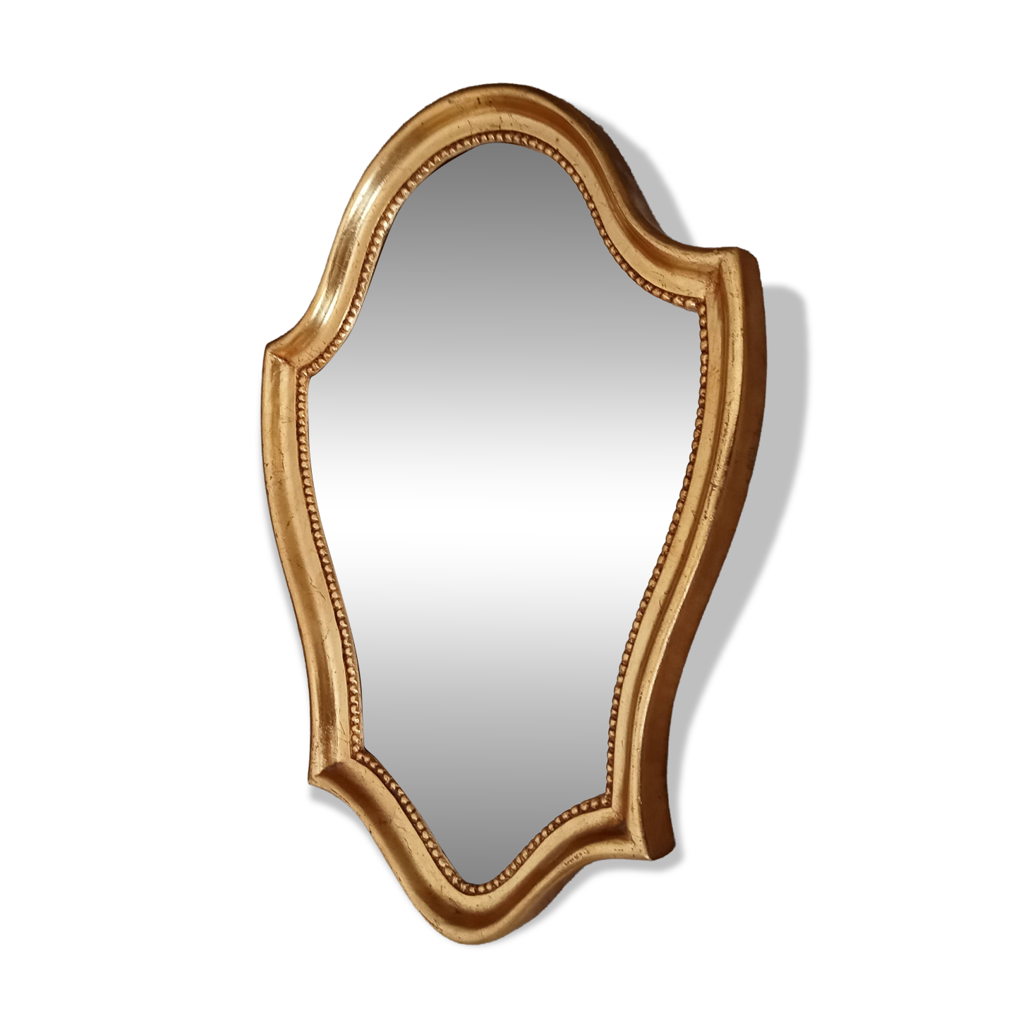 Vintage baroque mirror in gilded wood in the Louis XV style.