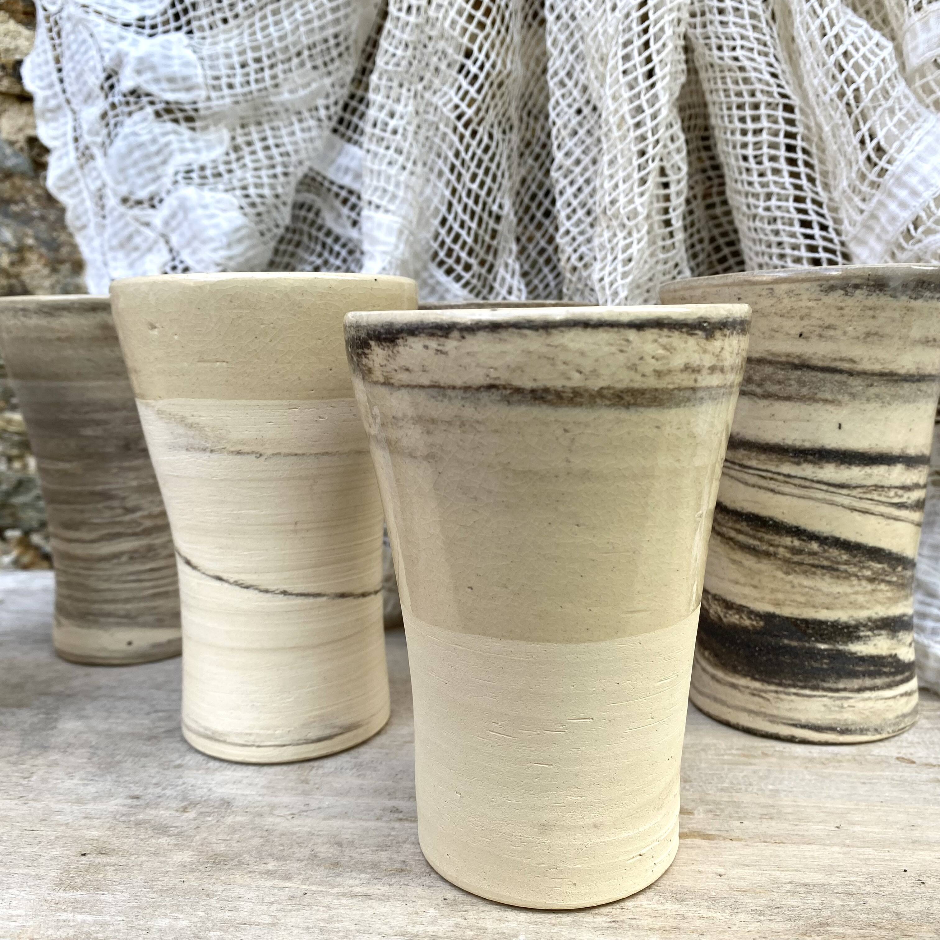 High ceramic cups made of mixed clay.