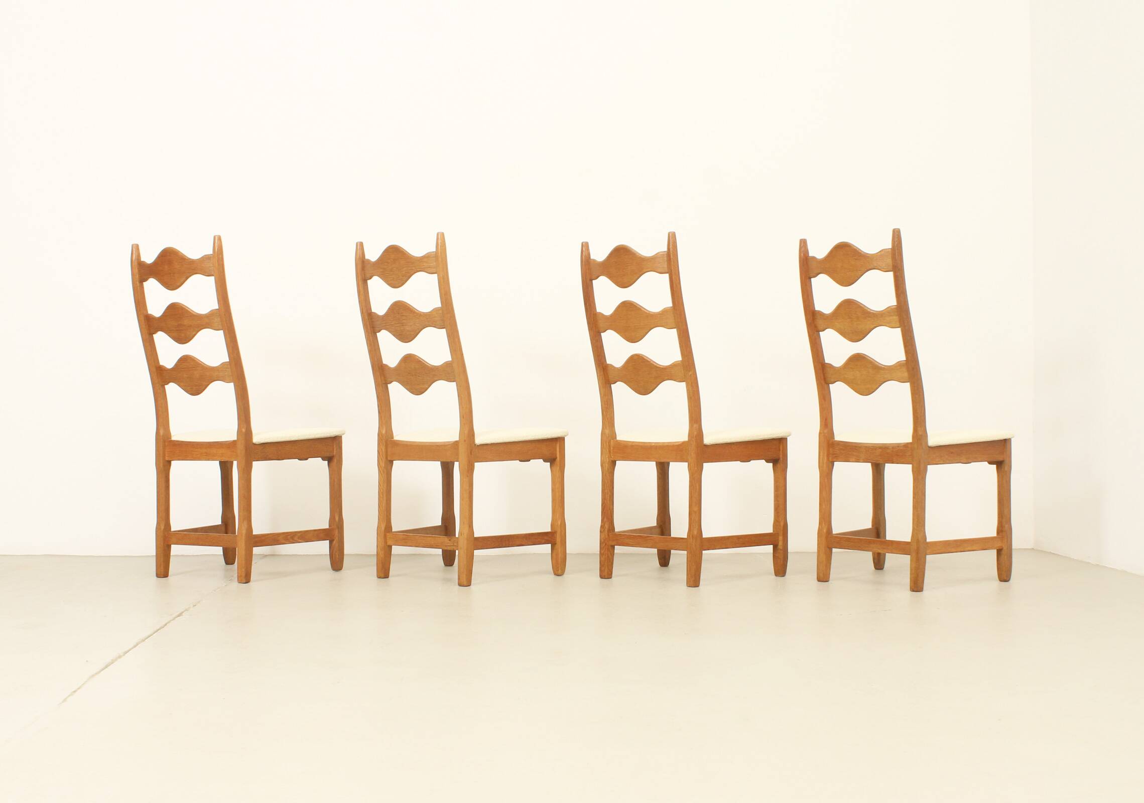 Four oak dining chairs by Henning Kjaernulf.
