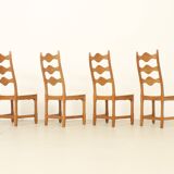 Four oak dining chairs by Henning Kjaernulf.