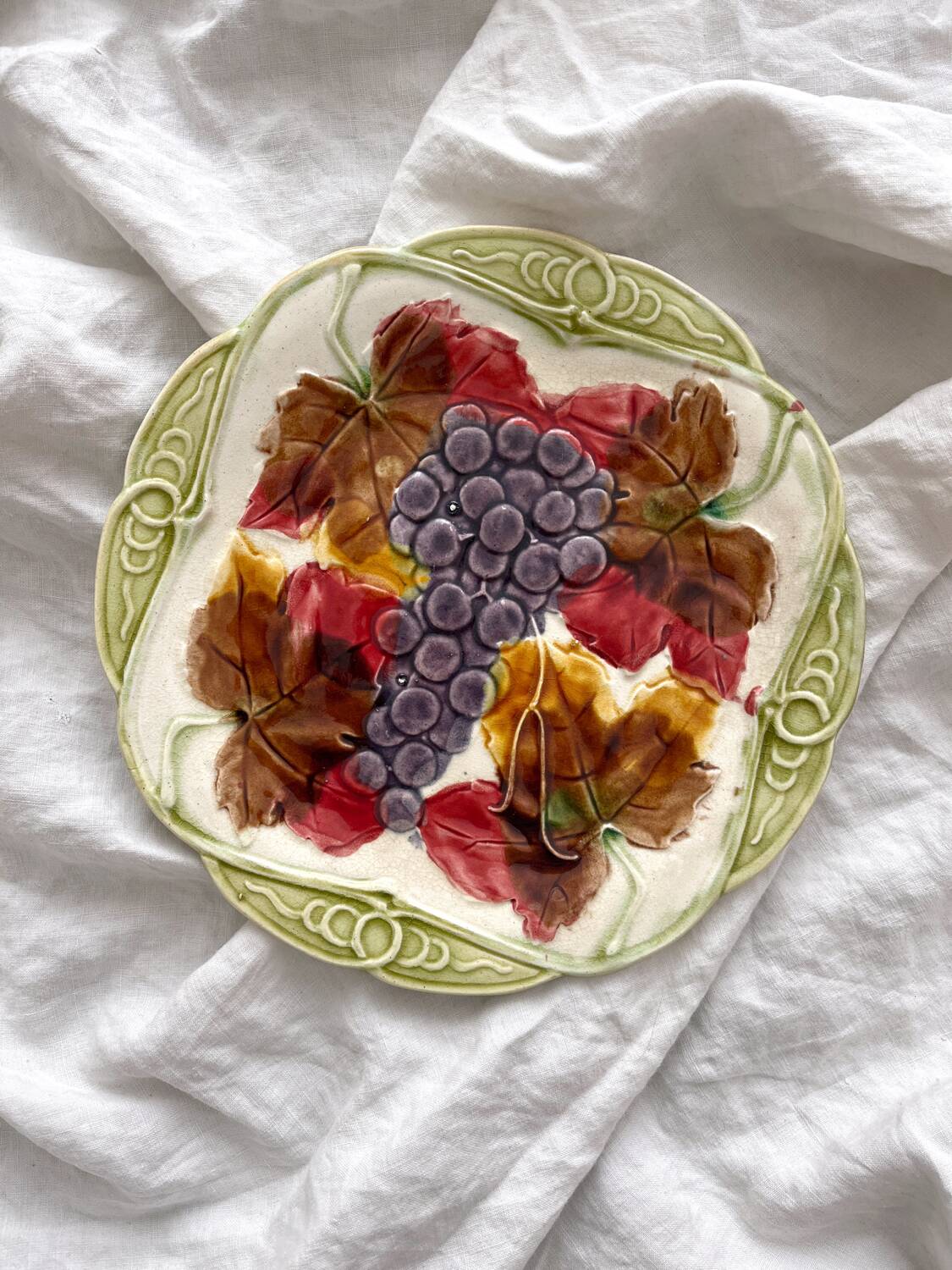 Antique plate in barbotine grapes and vine leaves from Orchies