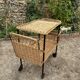 Vintage 1950s rolling dessert trolley in wicker and black tubing.