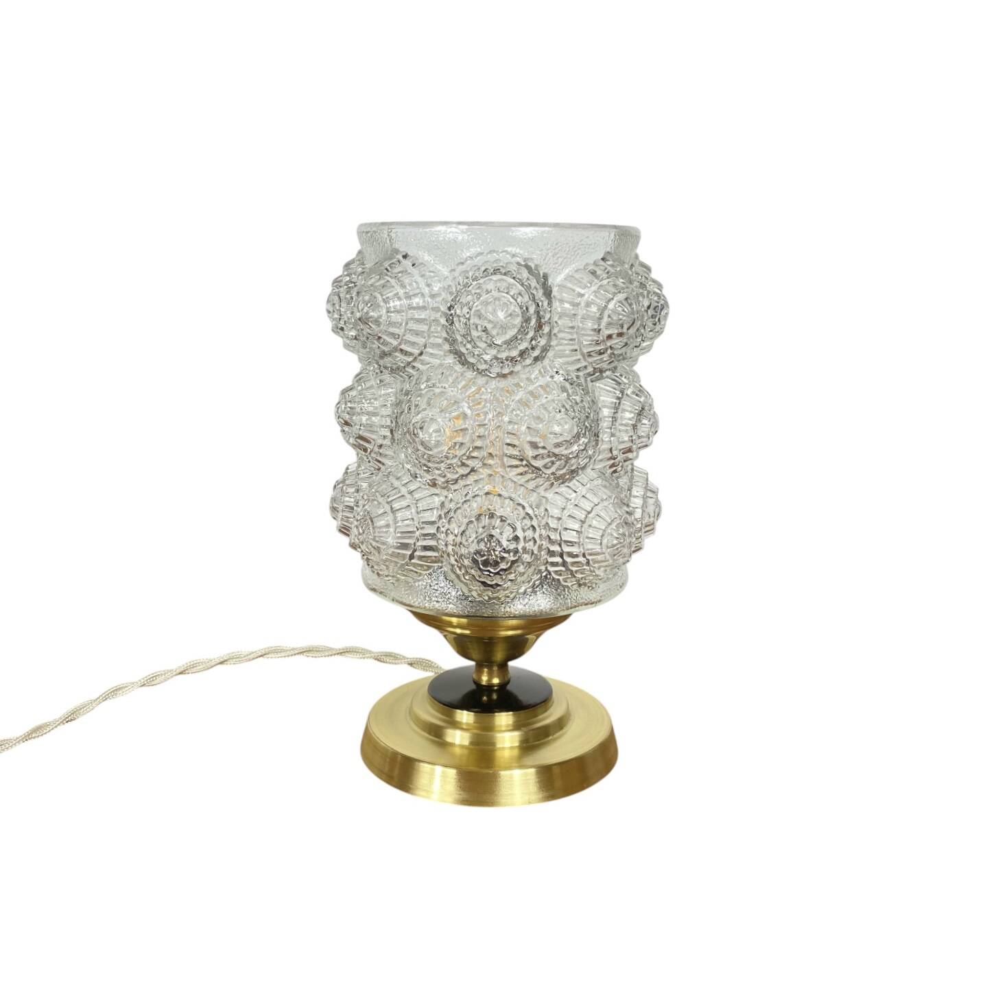 Antique globe table lamp in moulded transparent glass with a brass base.