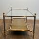 Coffee table in brass, brushed steel, glass, and gilded eglomisé mirror from Maison Jansen.