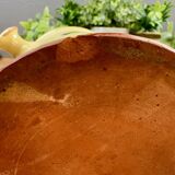 Antique ceramic pot with hand-painted floral decoration.