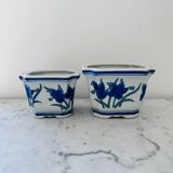 Duo of decorative plant pots with blue irises.