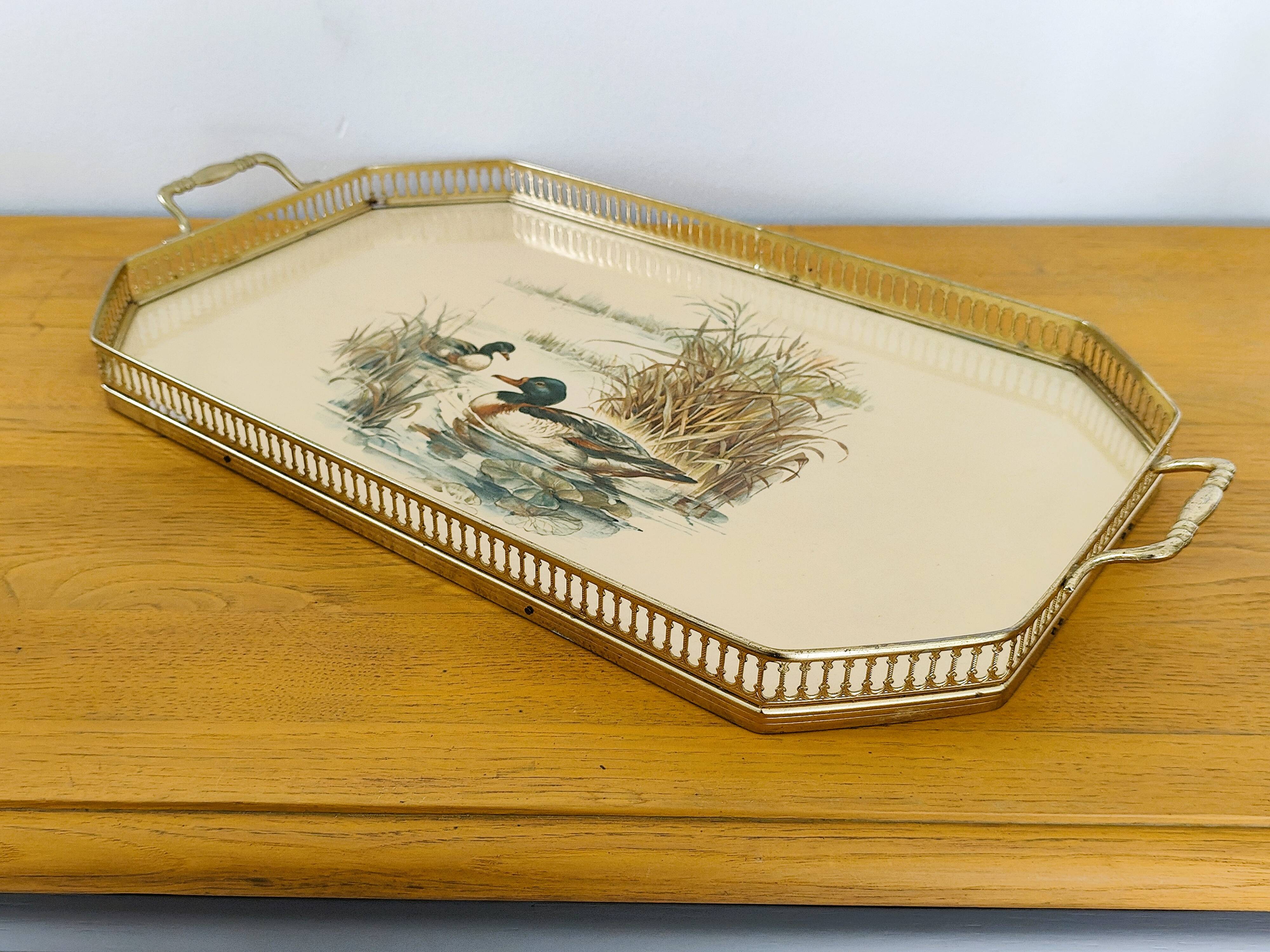 Vintage service tray with a golden gallery and mirror, decorated with ducks.