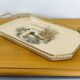 Vintage service tray with a golden gallery and mirror, decorated with ducks.