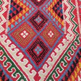 Red carpet with multicolored Berber patterns woven with hands