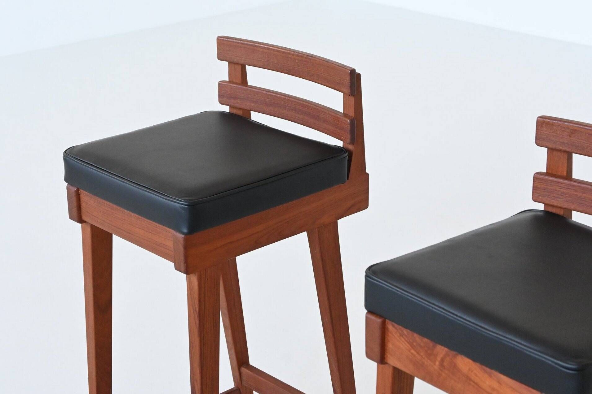 Erik Buck set of three bar stools in teak and leather Dyrlund Denmark 1960