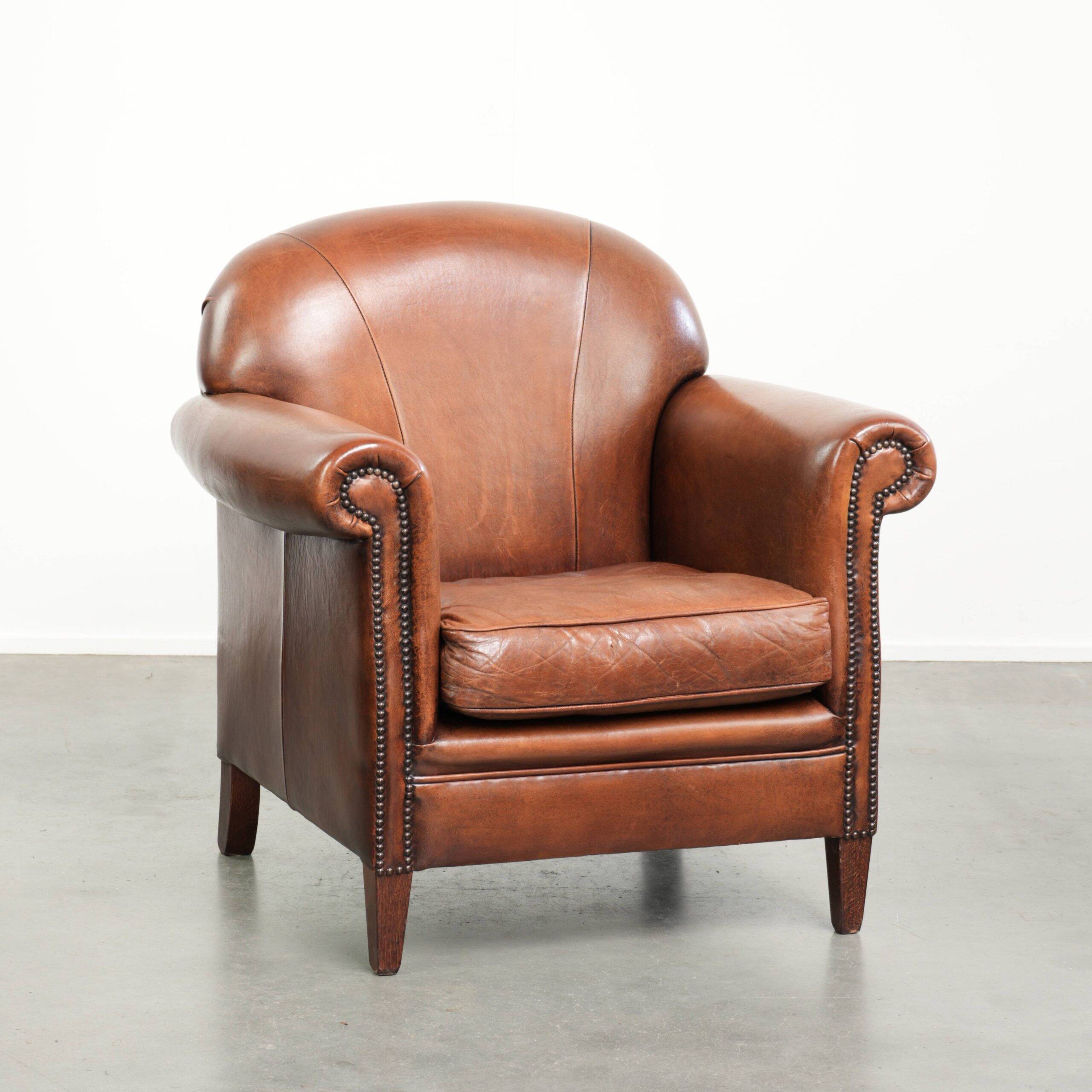 Sheepskin armchair with comfortable seat and finished with decorative nails
