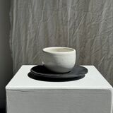 White Indonesian ceramic cup and gray saucer