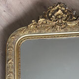 Golden mirror with a pediment from the early 20th century.