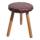 Leather-upholstered tripod stool