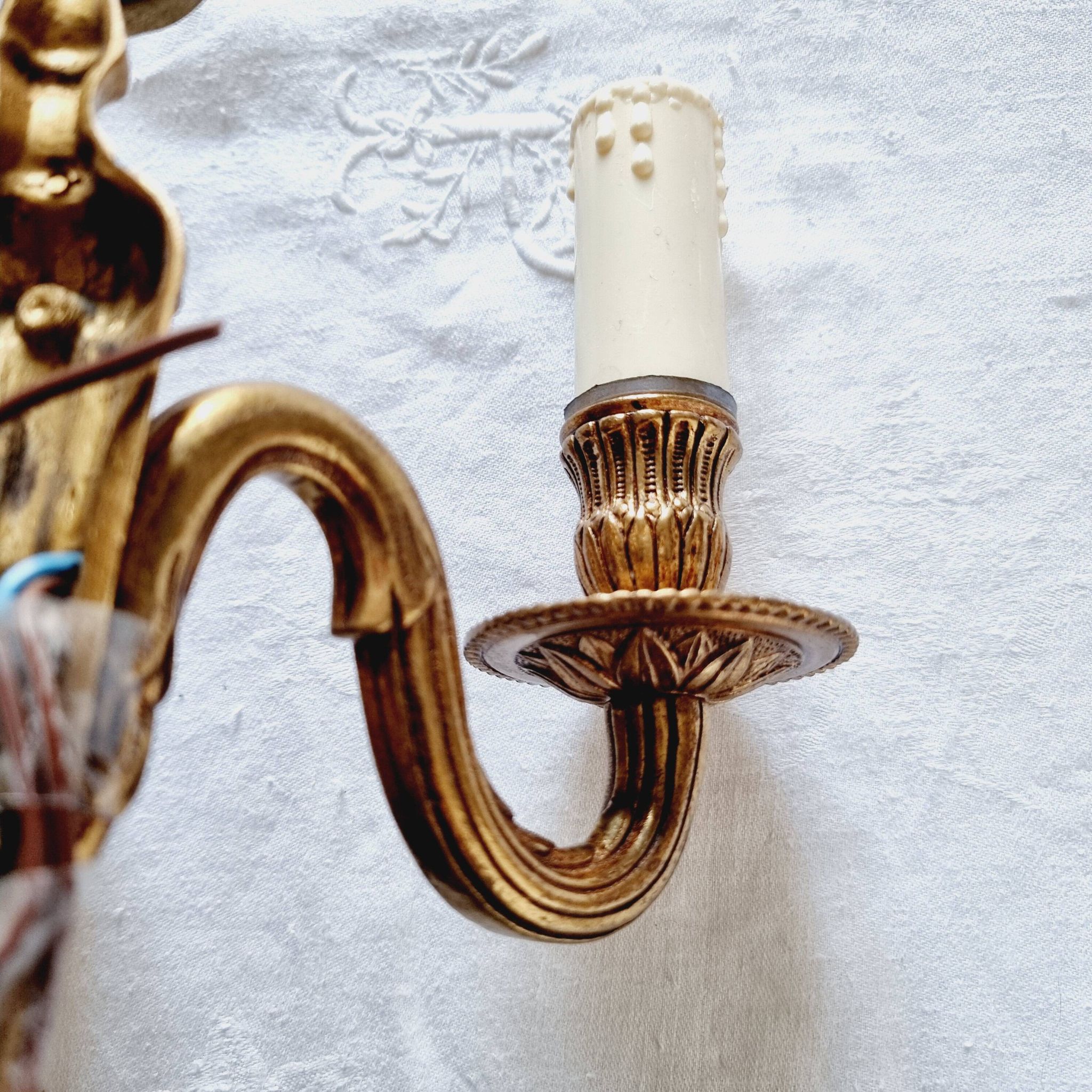 French Empire-style wall sconce or chandelier in bronze with an antique gold patina.