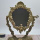Adjustable psyche mirror of 33 centimeters in gilded bronze with angel ornament