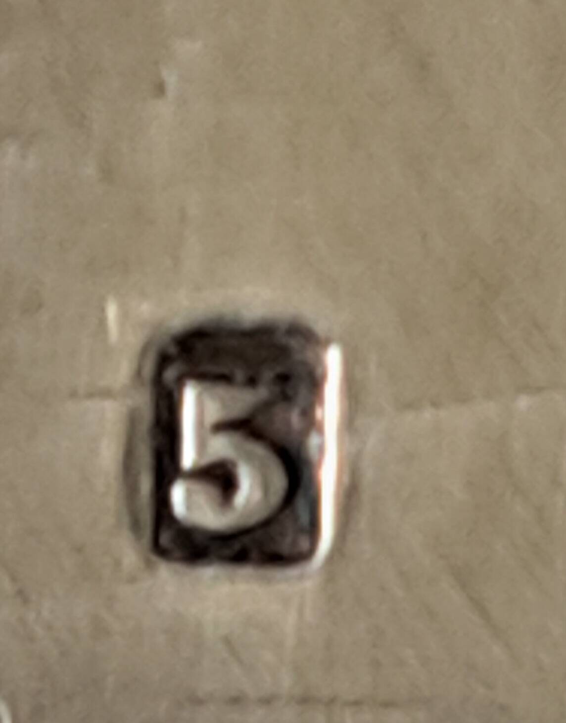 Silver metal cake peeler.