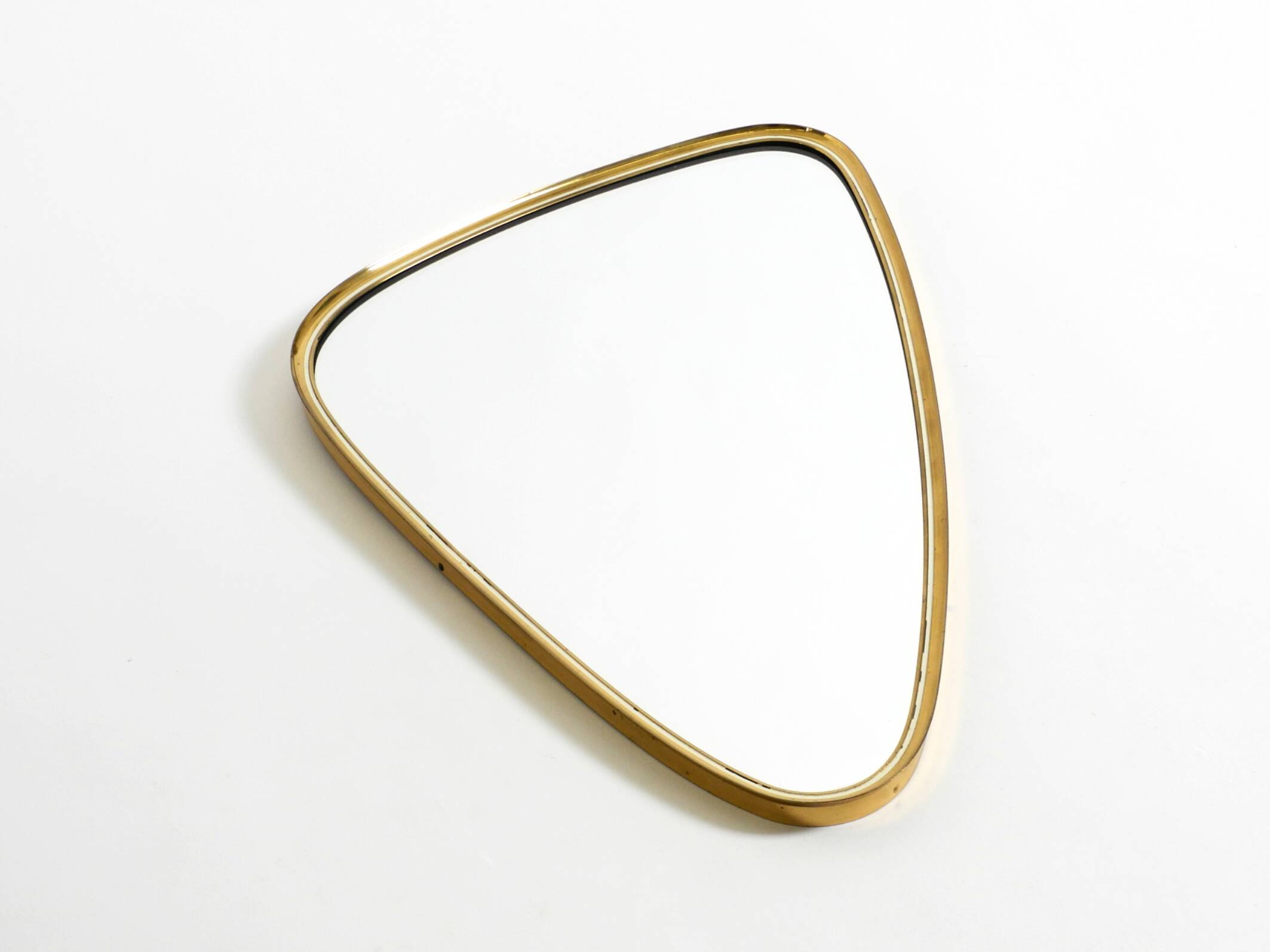 Heavy mid-century brass kidney-shaped wall mirror from Münchner Zierspiegel