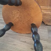 Brown and black wooden tripod stool