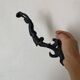 Antique cast iron coat hook with swimmer and shell basin.