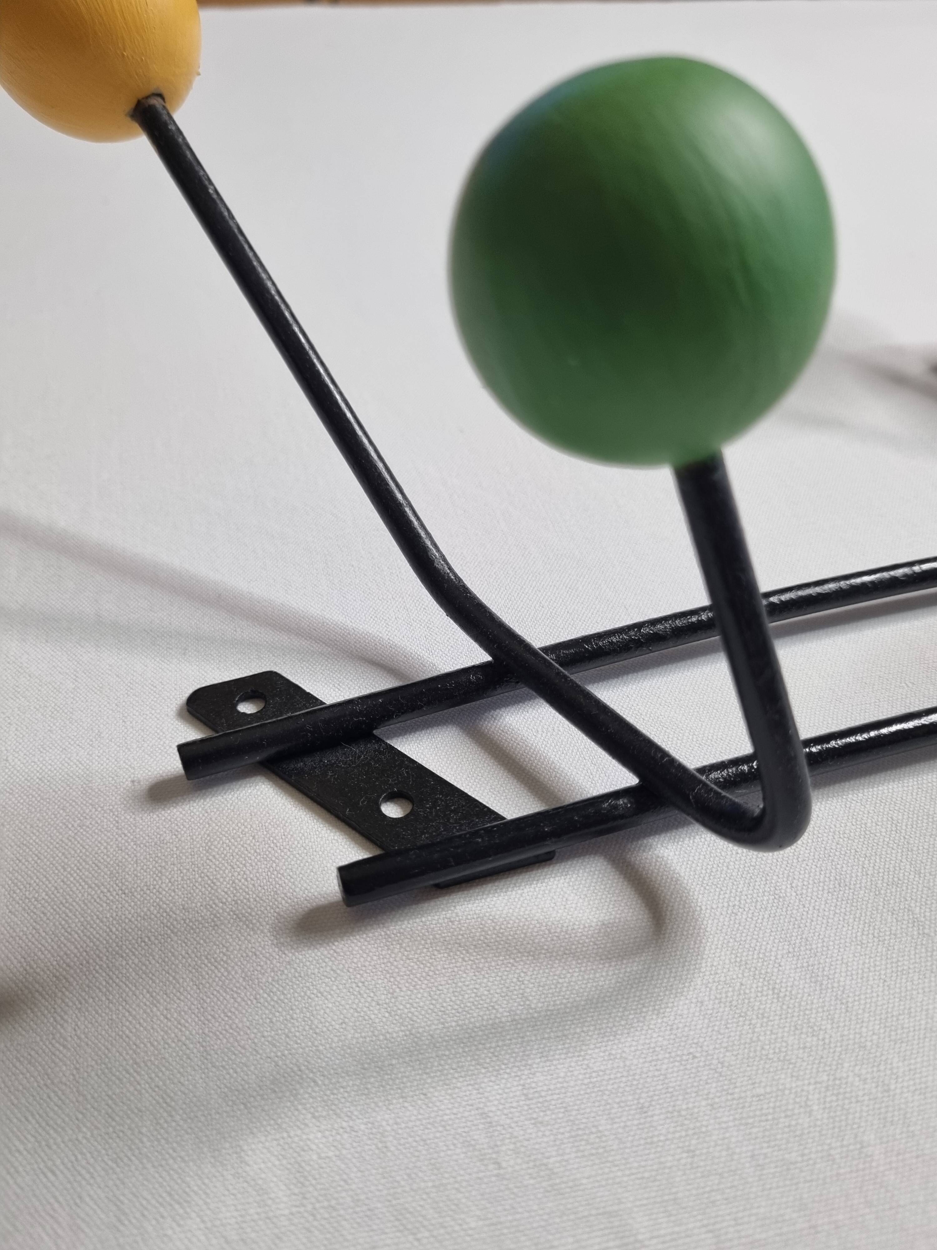 Vintage wall coat rack in black metal and wood, Roger Féraud style from the 1960s.