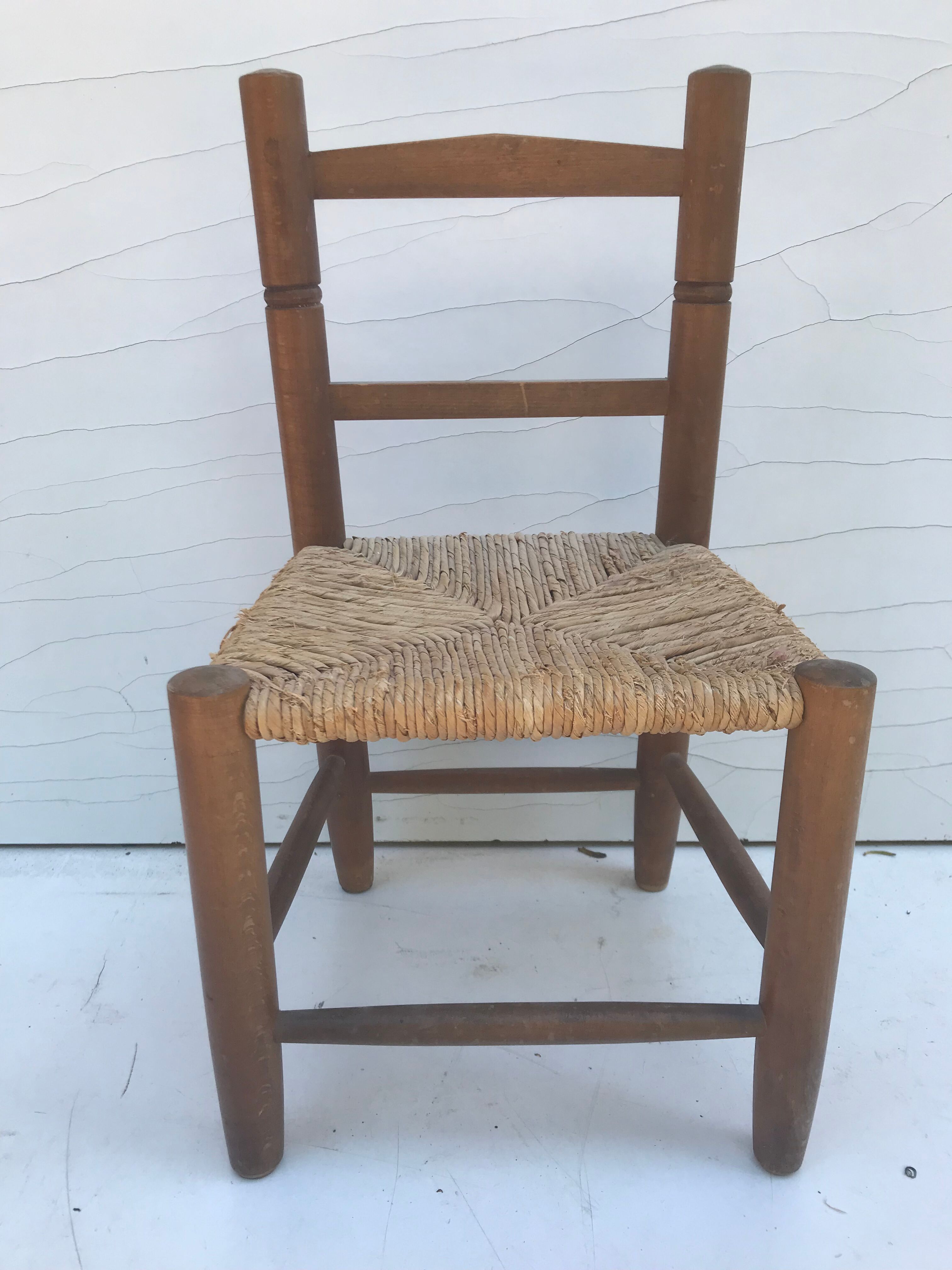 Old wooden children's chair with vintage braided seat