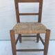 Old wooden children's chair with vintage braided seat
