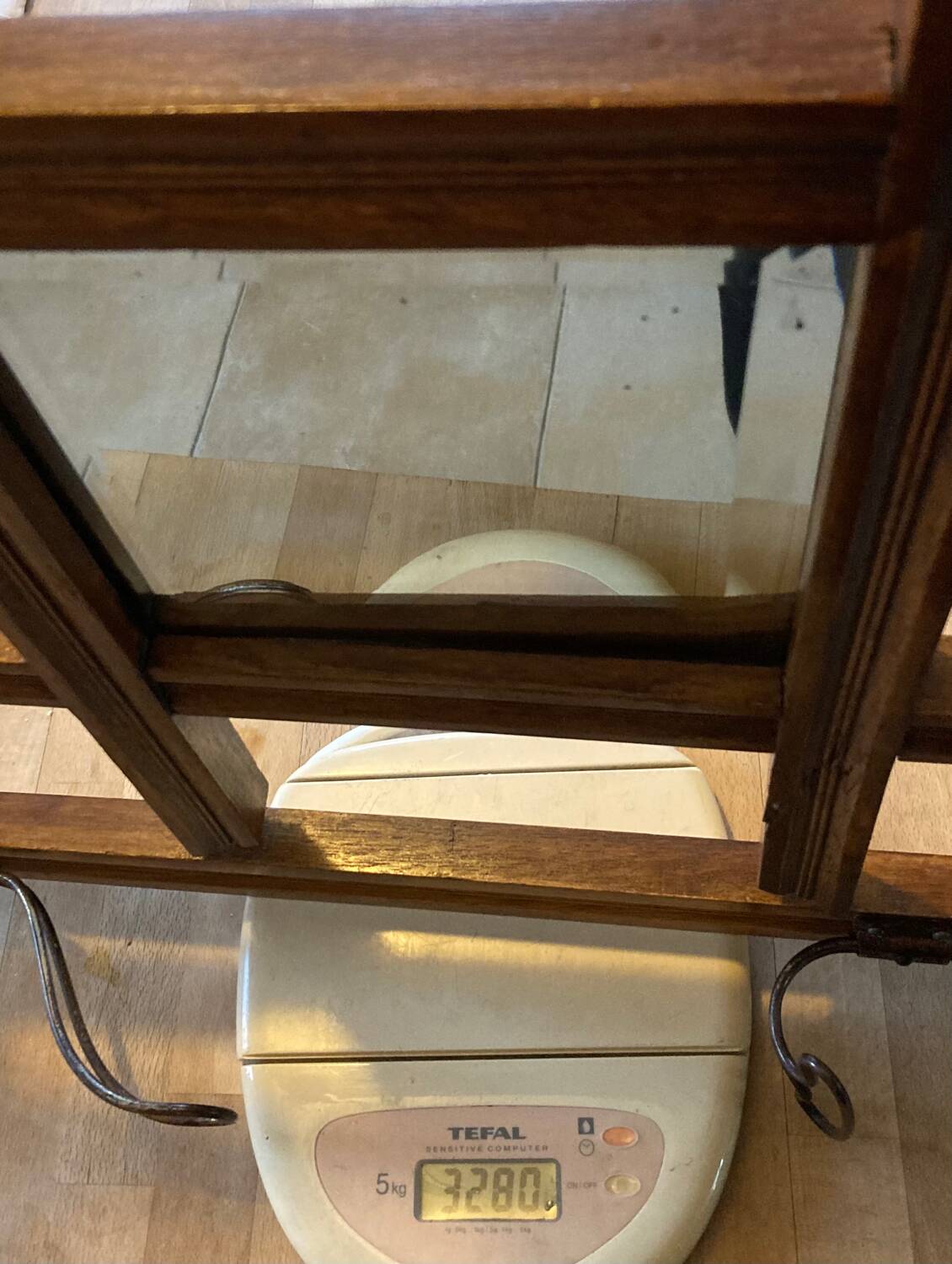 Art Deco wall-mounted coat rack in oak, early 20th century. Beveled central mirror