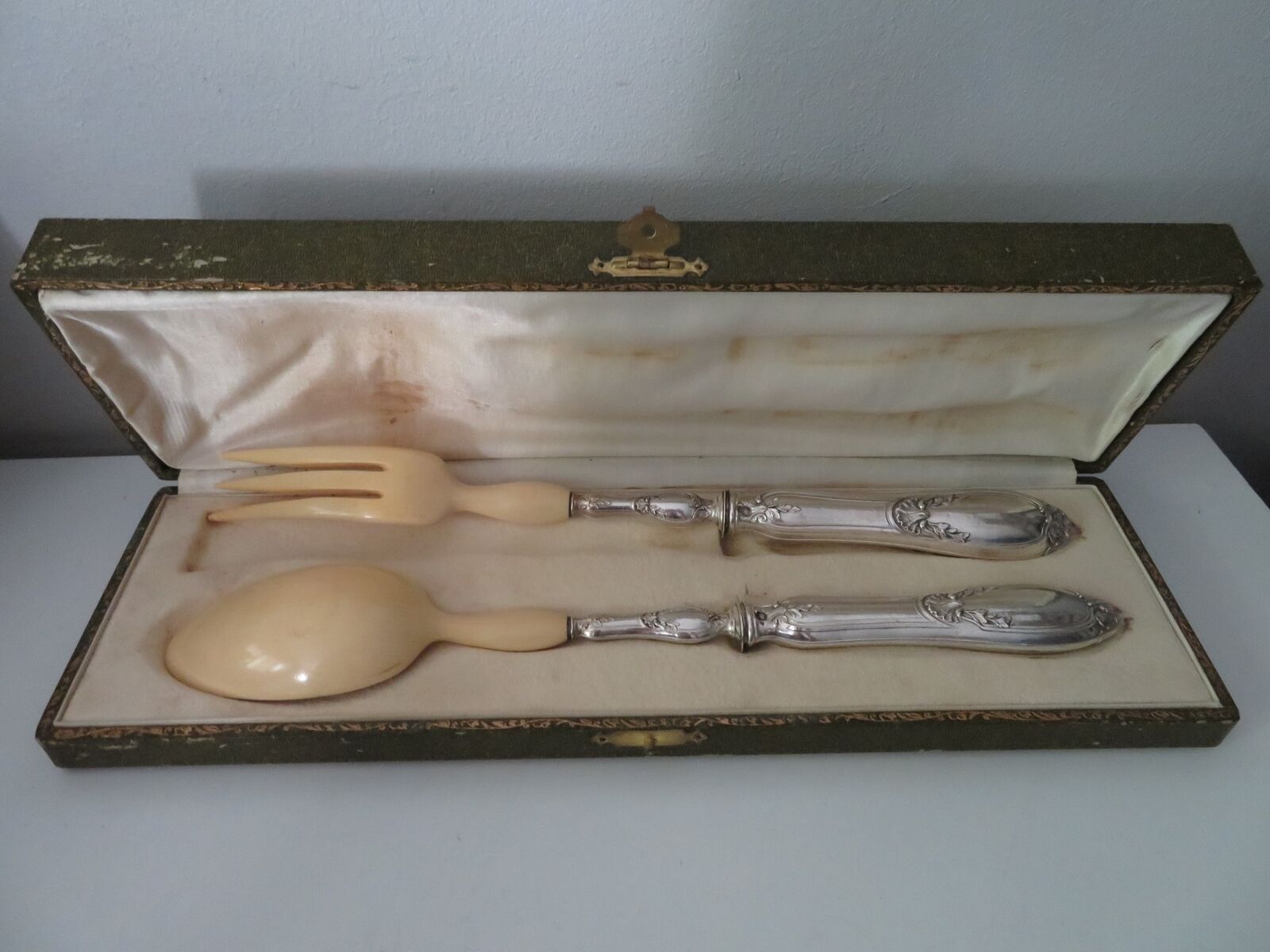 Silver salad servers stuffed in its case
