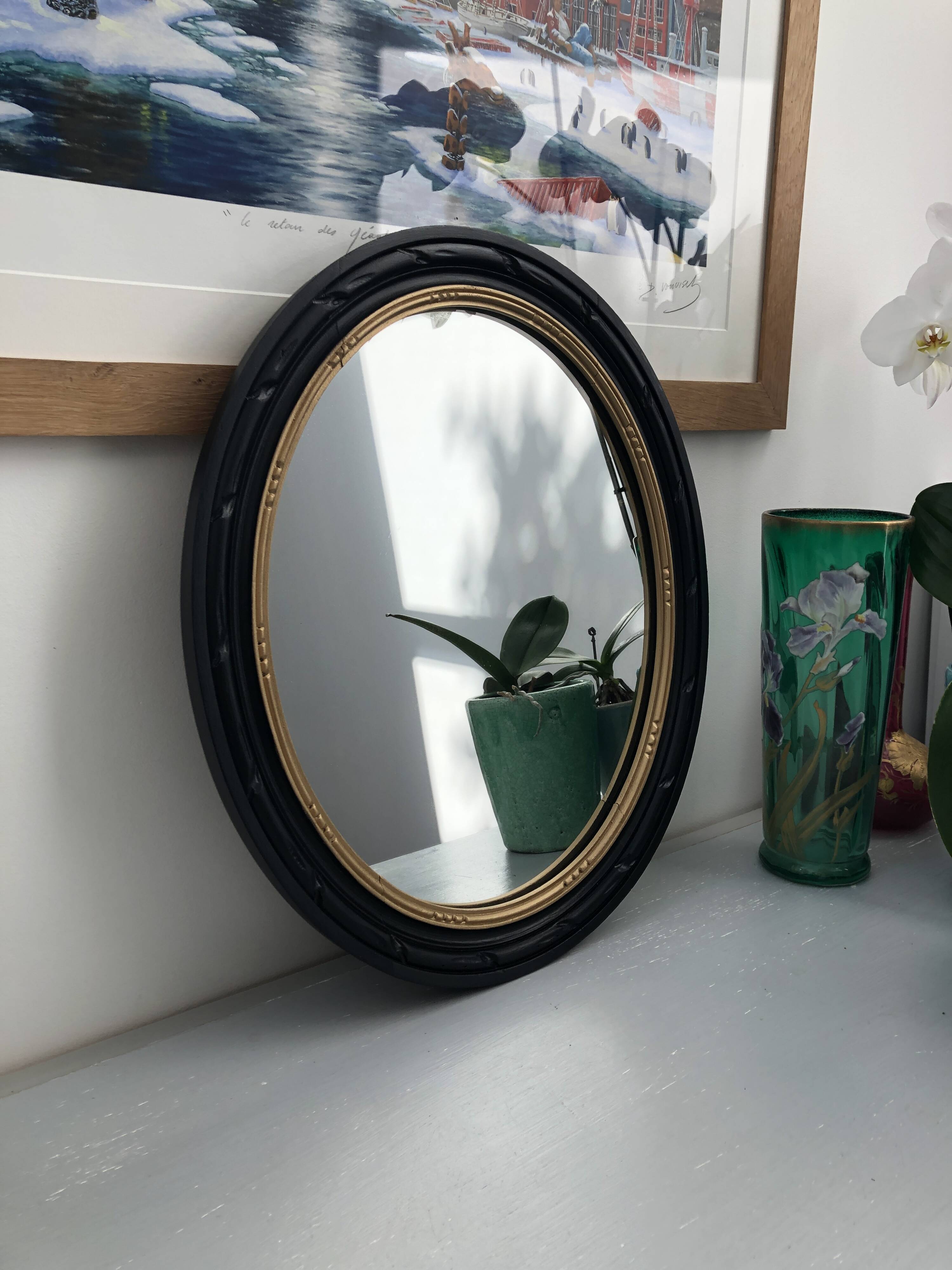 black and gold oval mirror
