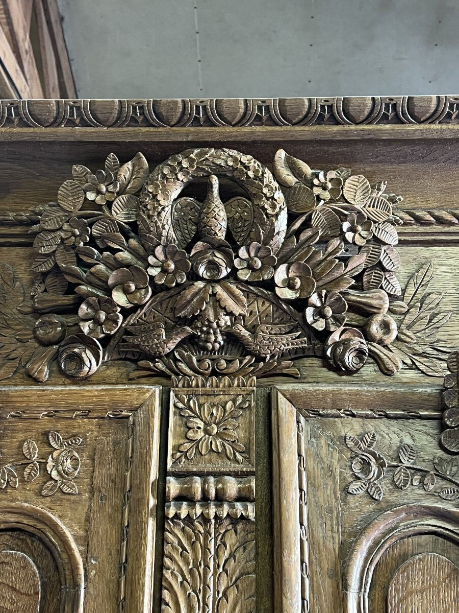 19th-century Norman wedding armoire, with bouquets of flowers and doves.