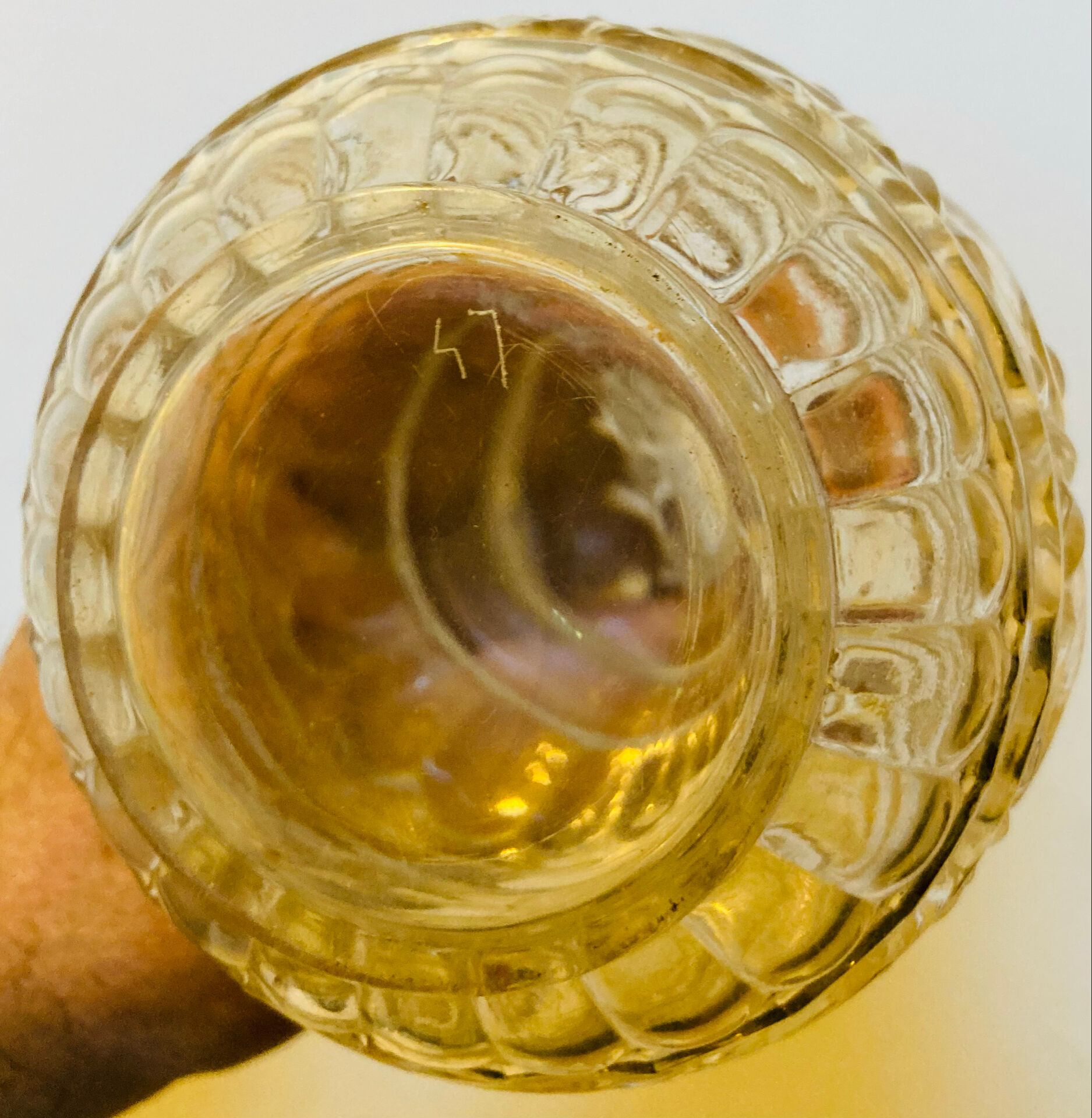 19th-century liqueur carafe in glass adorned with relief patterns.