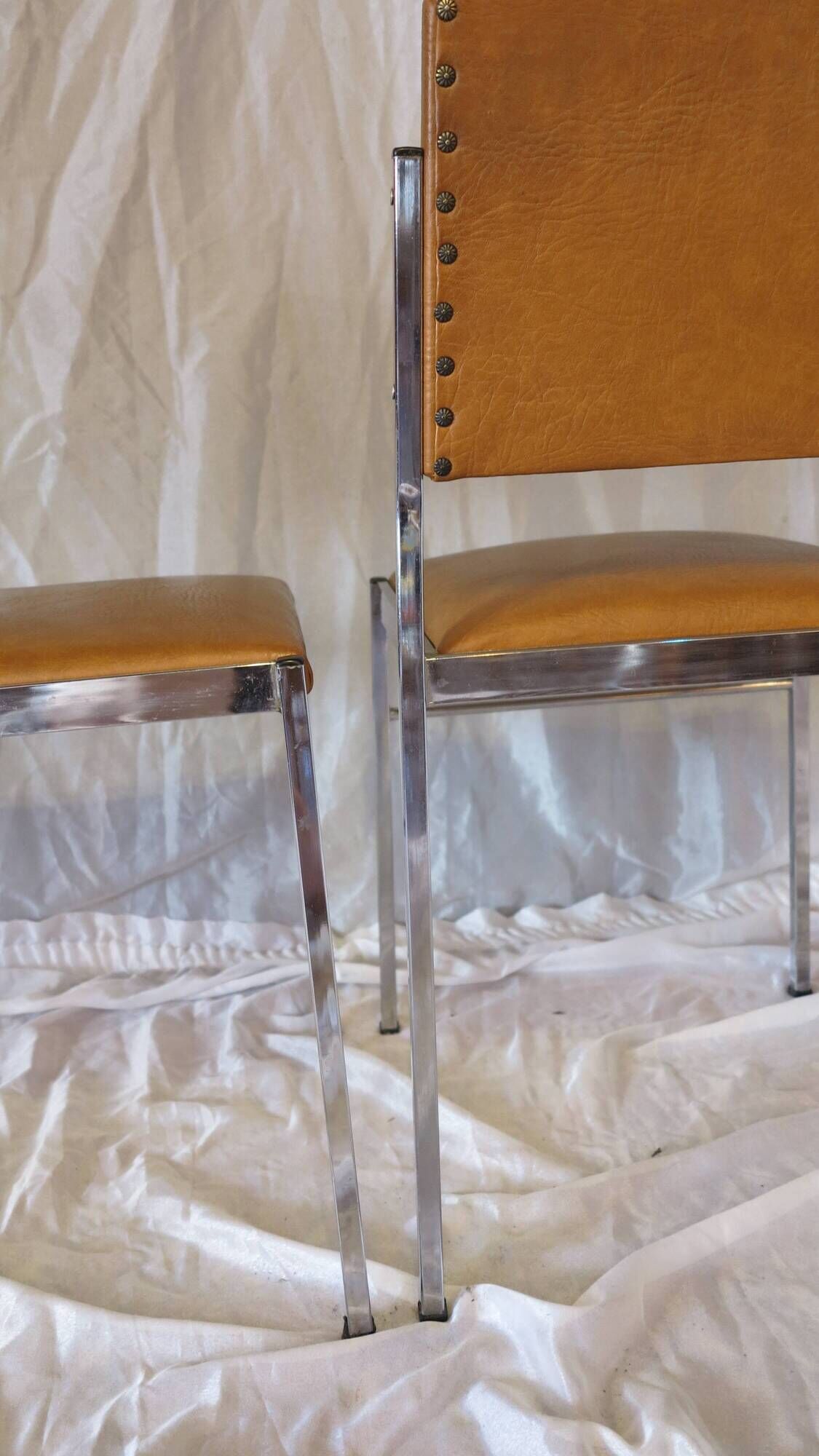 Pair of modernist chairs in chromed metal and imitation leather