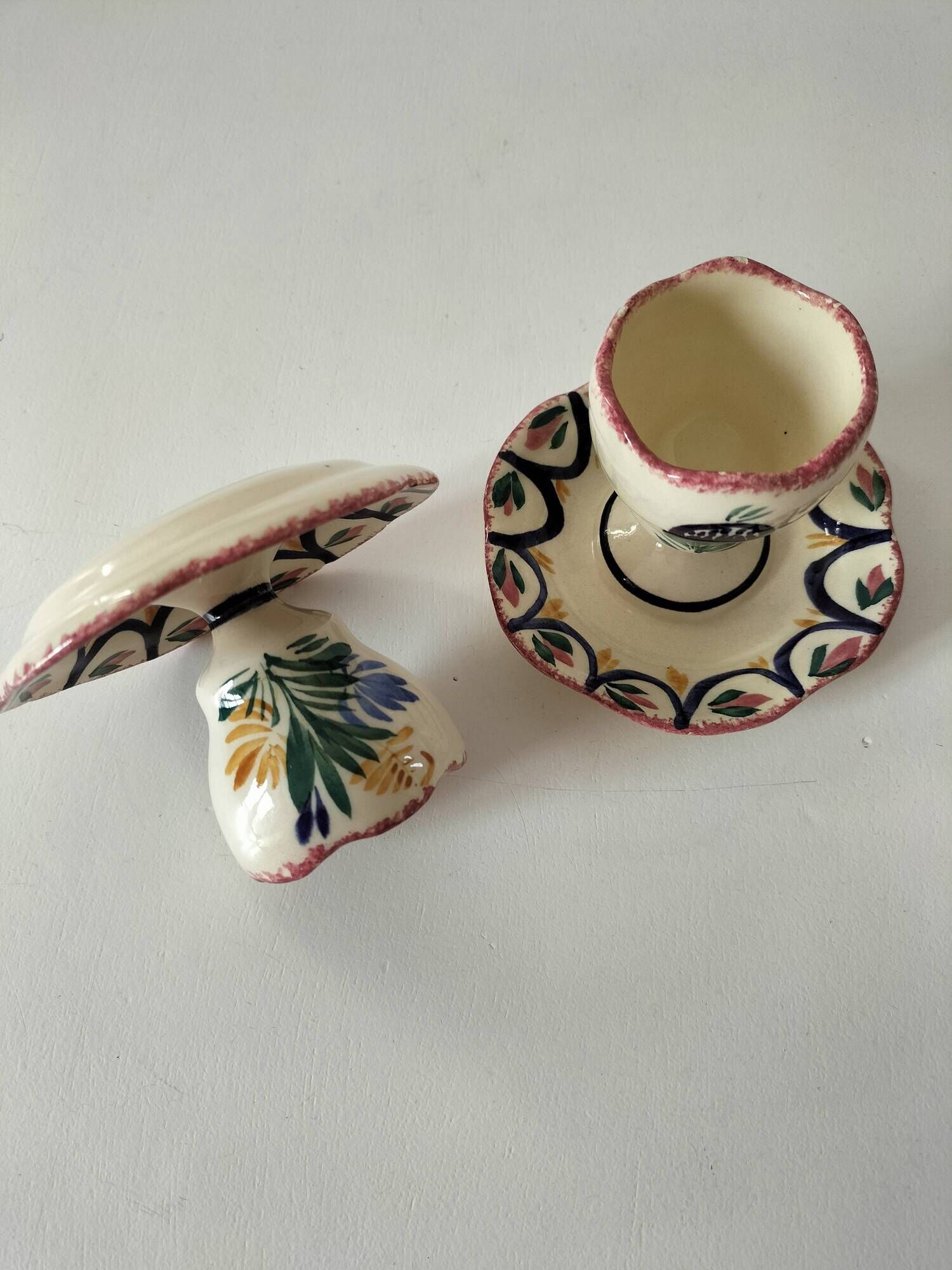Pair of HB Quimper egg cups with integrated pedestal base, floral decoration