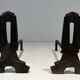 Pair of Modernist Andirons in Cast Iron with Openwork Uprights and Tripod Bases