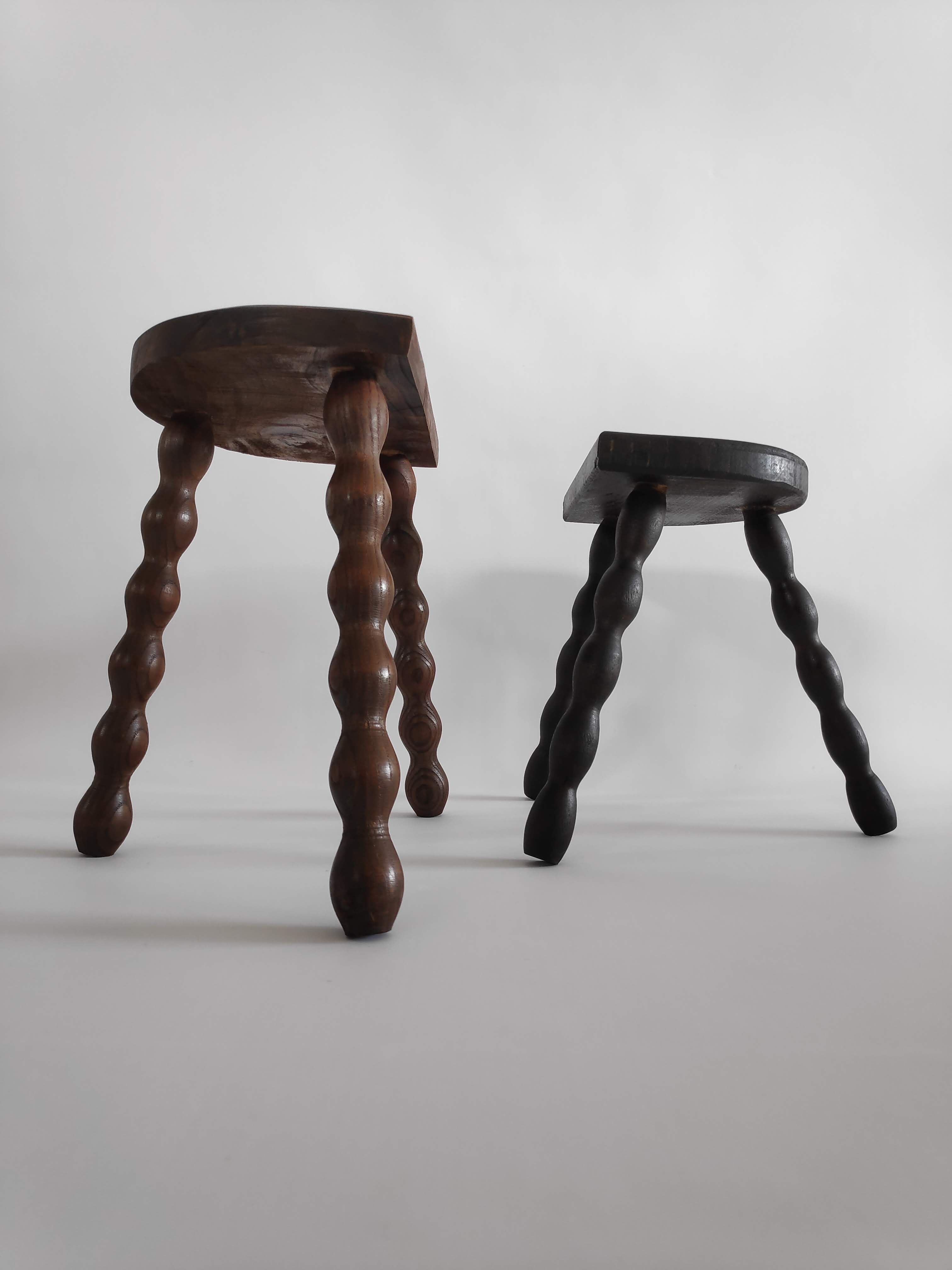 Pair of vintage tripod stools with turned wooden feet