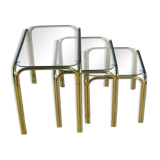 Nested tubular tables in gold metal.