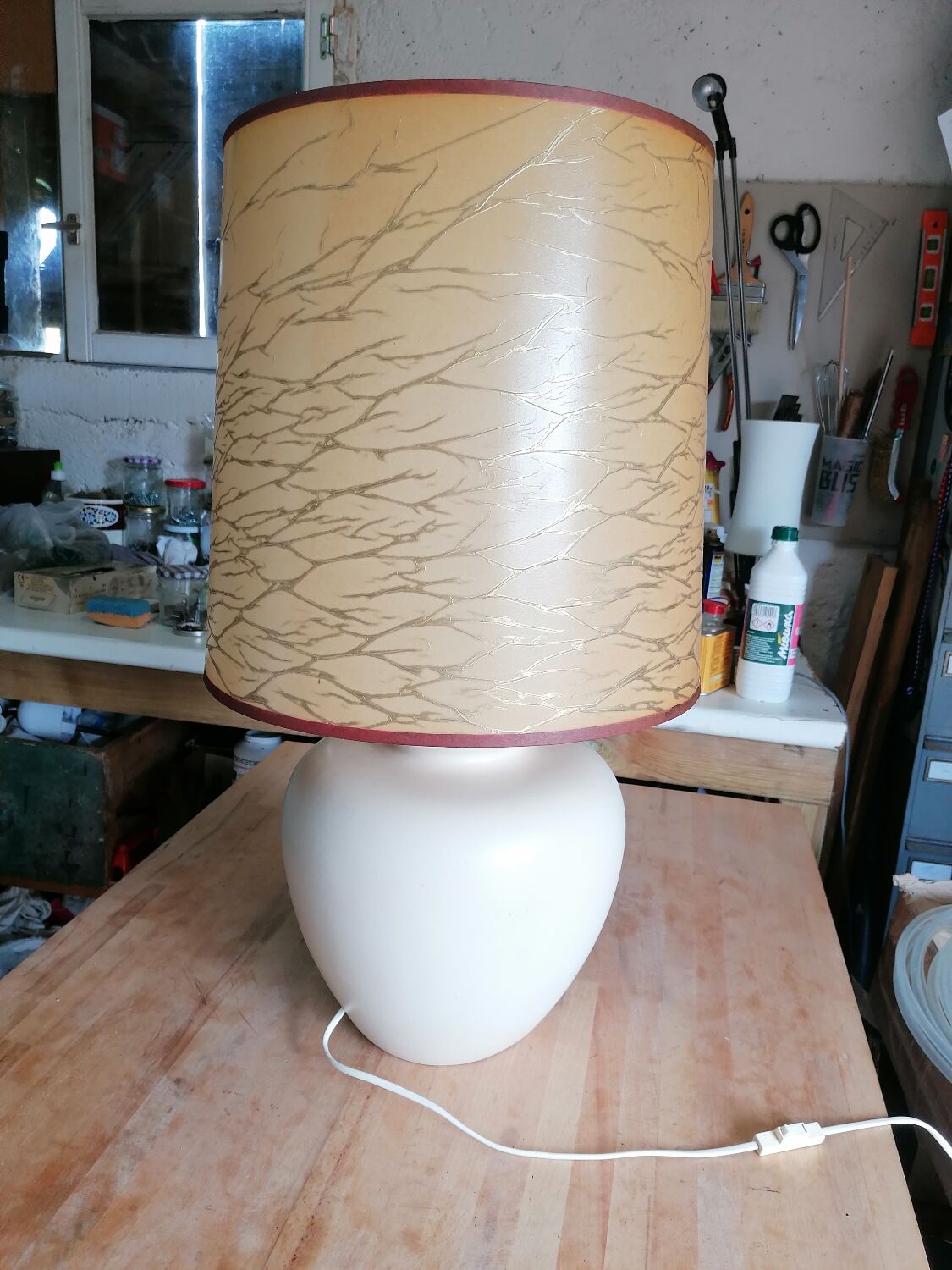 Vintage ceramic table lamp and golden lampshade.