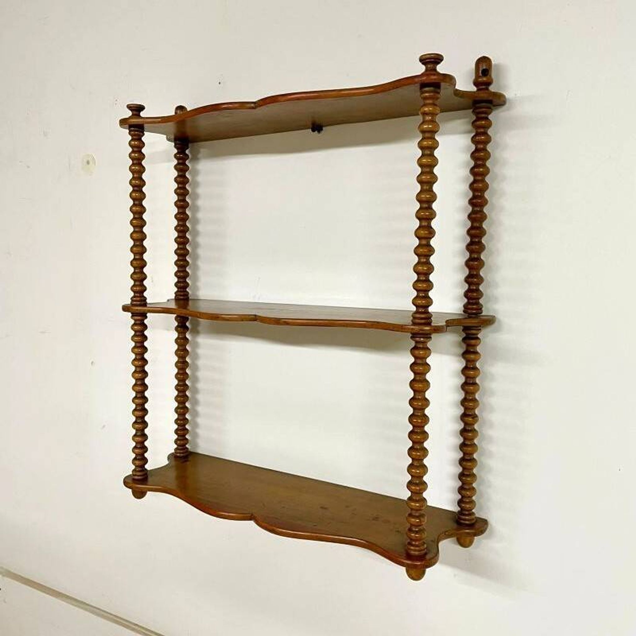 Vintage turned wood wall shelf with 3 levels.