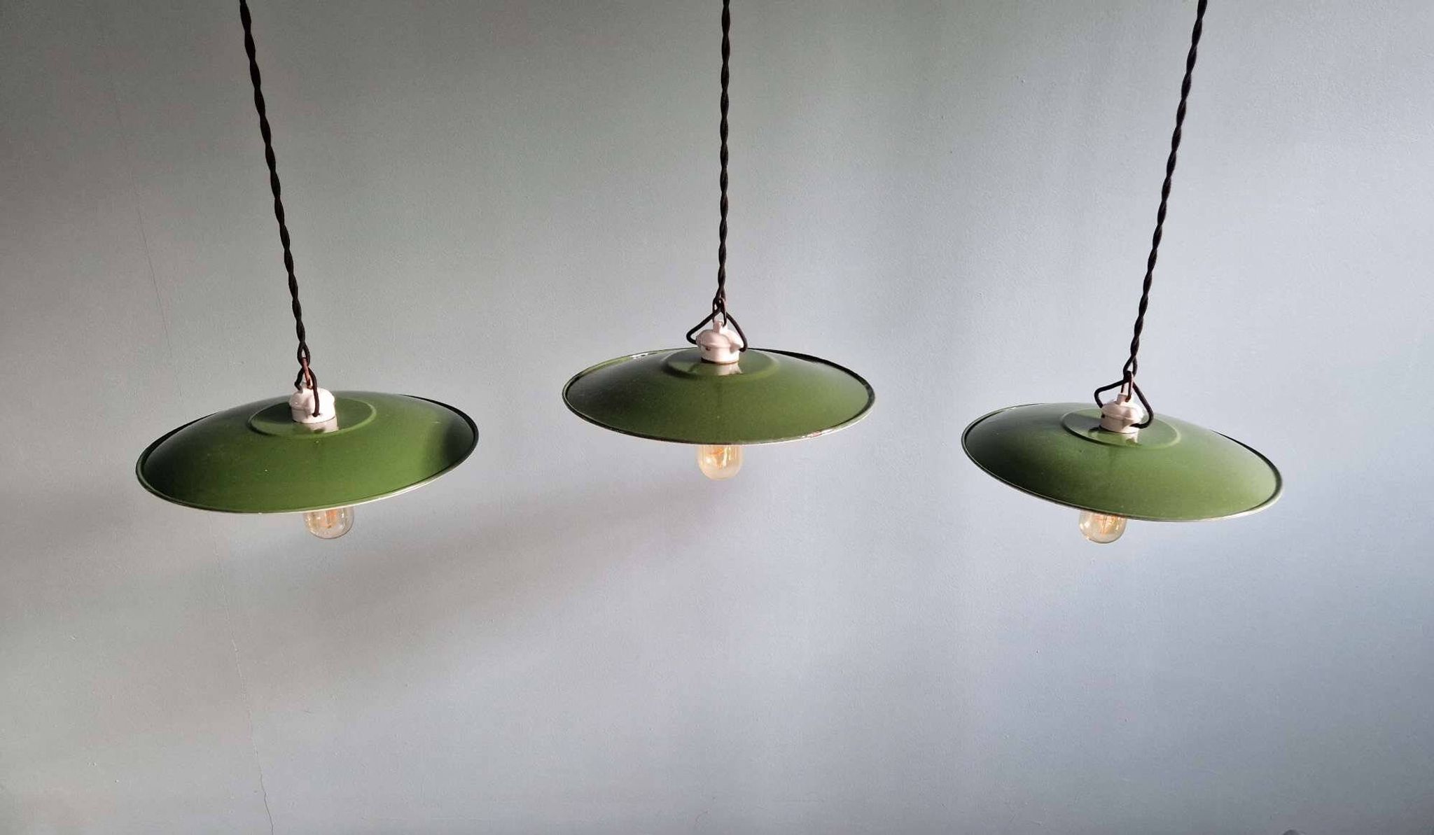 Trio of large industrial suspensions in green enamelled sheet metal.