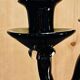 Set of four black glass candle holders.