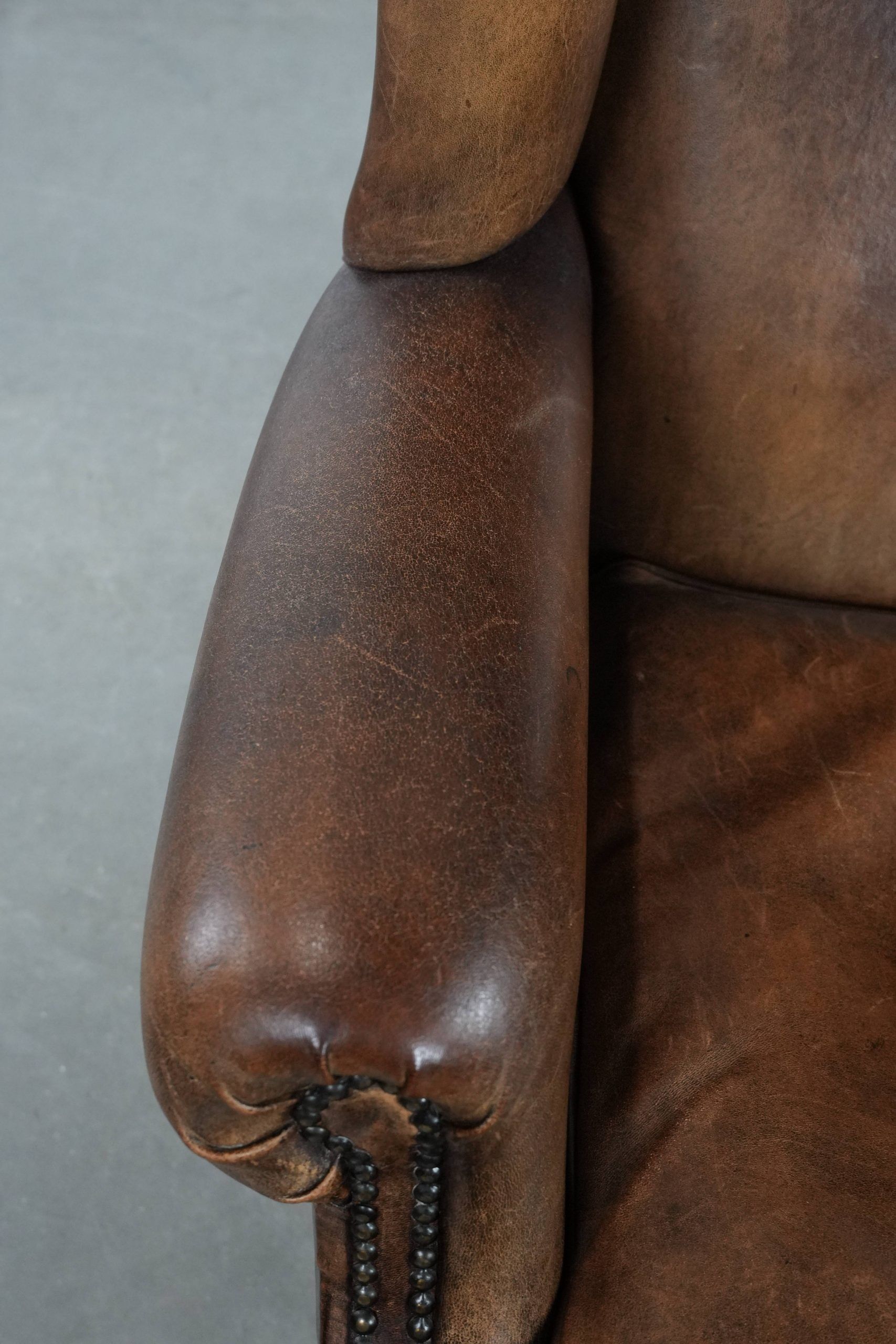 Warm, cosy and comfortable vintage sheepskin ear armchair with character