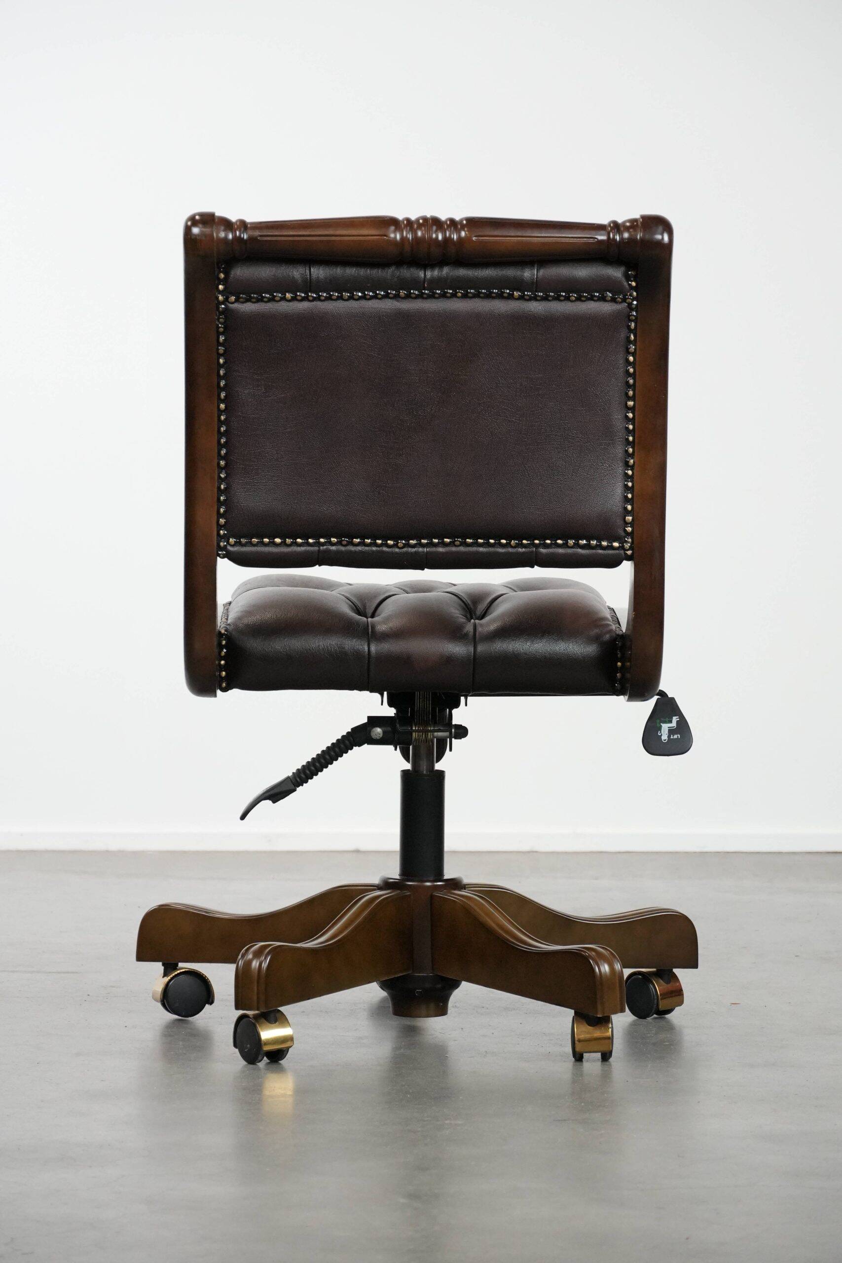 Chesterfield office chair in English style made of cow leather and wood.