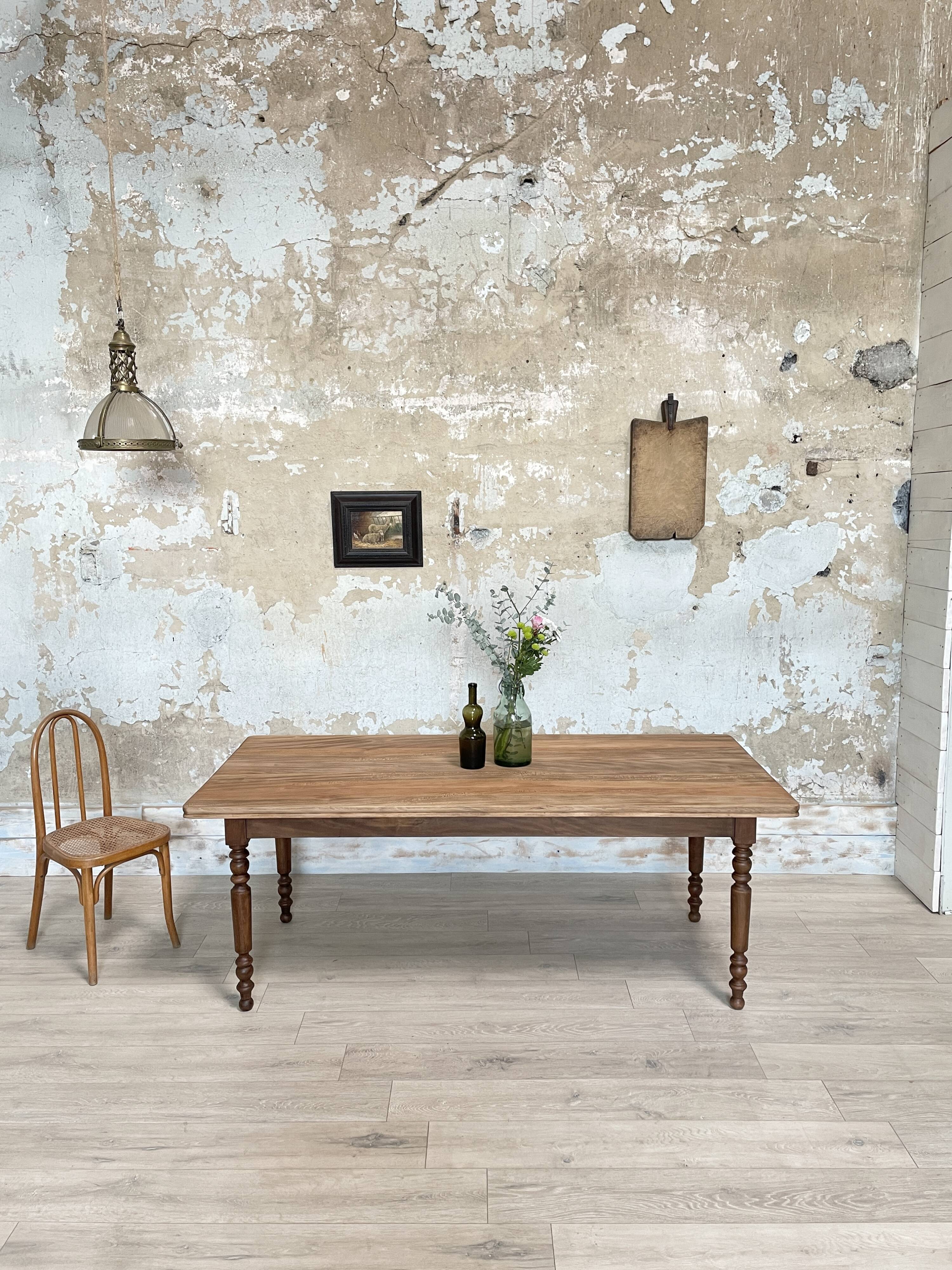 Vintage farmhouse table with turned legs.