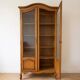 Antique wooden display cabinet with glass doors.