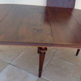 Extendable mahogany table with 6 tapered and fluted legs, Louis XVI style
