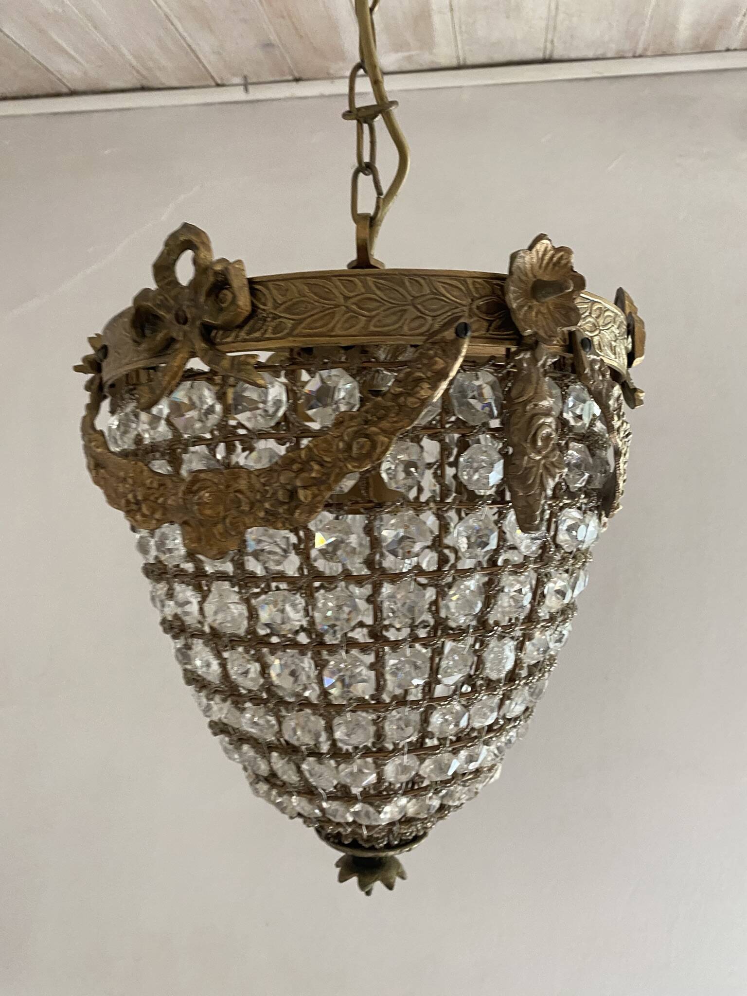 Brass basket chandelier with Louis XVI style pendants.