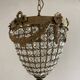 Brass basket chandelier with Louis XVI style pendants.