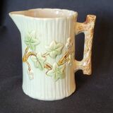 Old pitcher in slip 1900 ivy or holly decoration