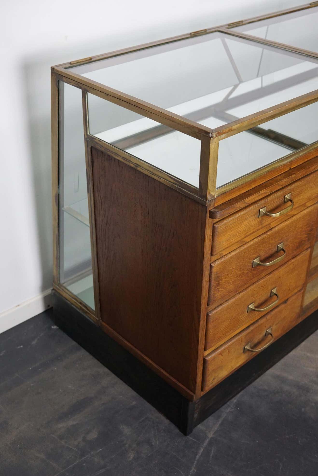 Counter or shop window in oak glass and brass France around 1920